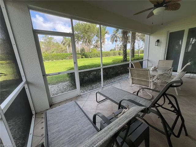 a view of a porch with furniture and a yard