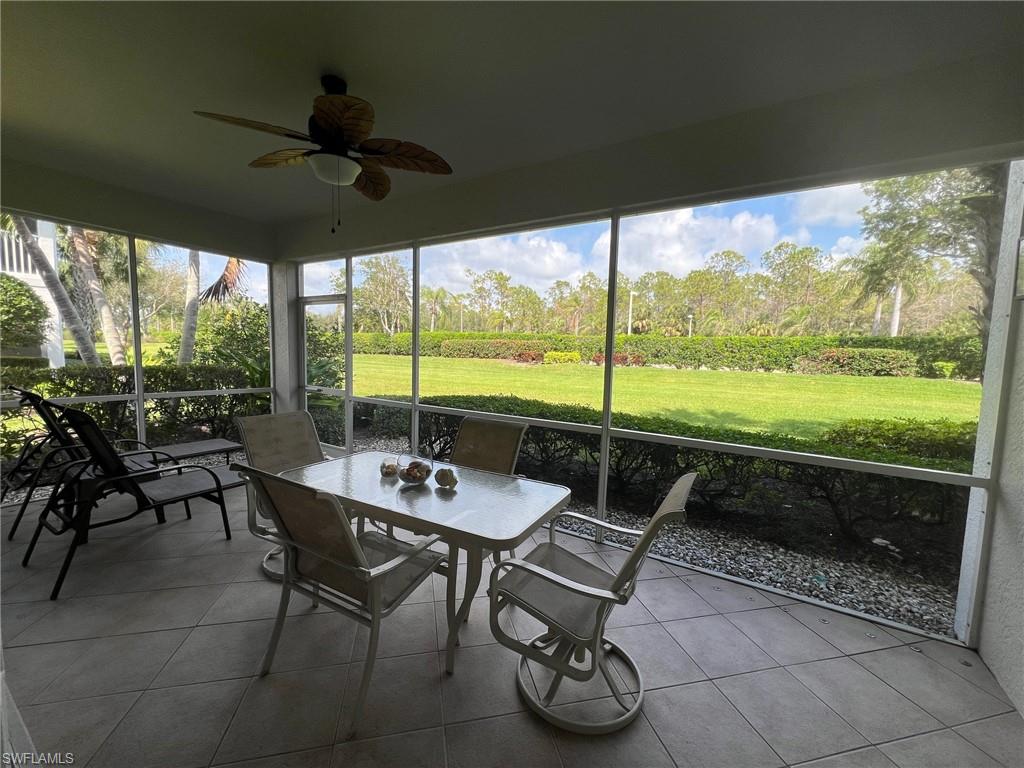 6864 Ascot Drive, Unit 101 Naples, FL 34113 - Photo 26 of 40 a view of a porch with furniture and a yard