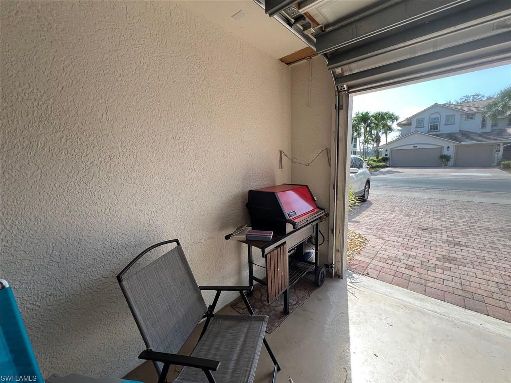 6864 Ascot Drive, Unit 101 Naples, FL 34113 - Photo 29 of 40 a view of a workspace with furniture and a window
