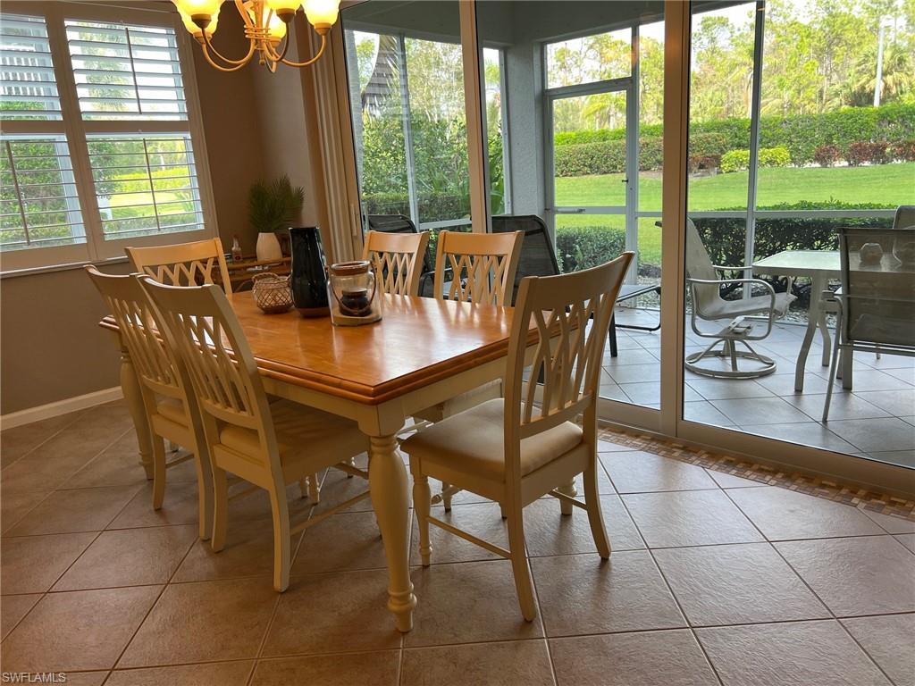 6864 Ascot Drive, Unit 101 Naples, FL 34113 - Photo 8 of 40 a view of a dining room with furniture window and outside view