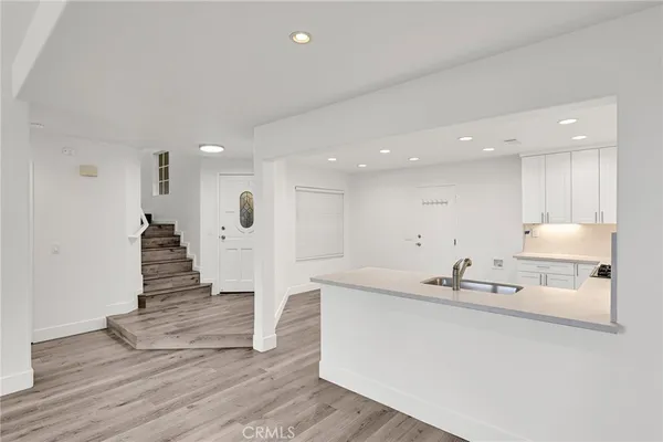 a view of kitchen with wooden floor and electronic appliances