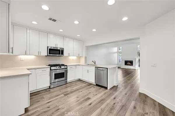 a kitchen with stove a sink and microwave