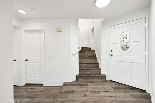 a view of an entryway with wooden floor
