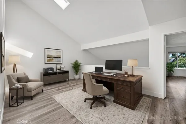 a view of a workspace with furniture and a bedroom