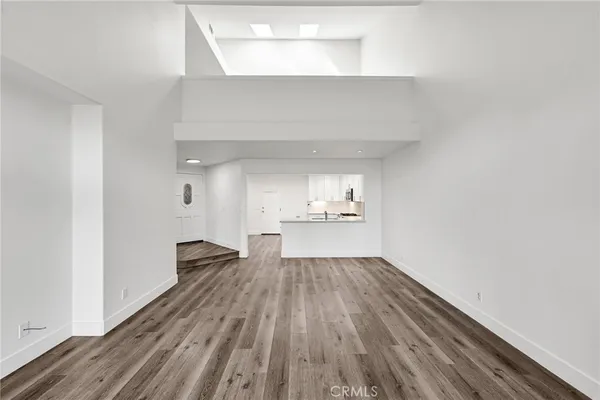 a view of a kitchen with wooden floor