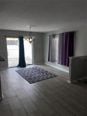 a view of a livingroom with wooden floor and windows