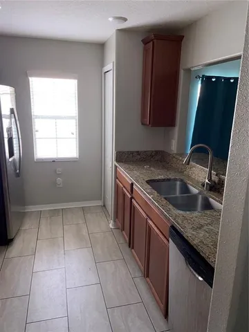 a kitchen with a sink stove and mirror