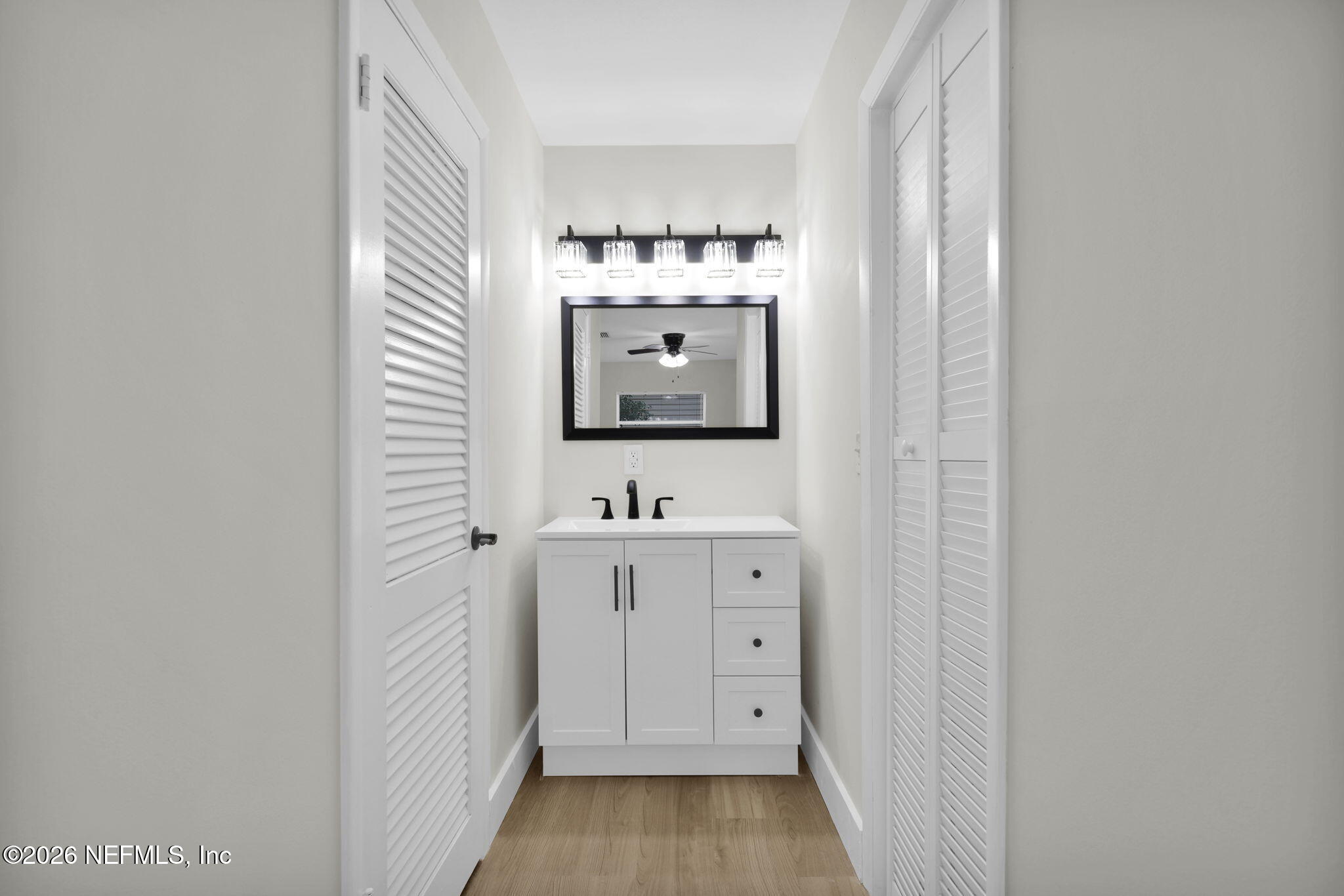 8544 Sanchez Road Jacksonville, FL 32217 - Photo 36 of 46 a bathroom with a sink and a mirror