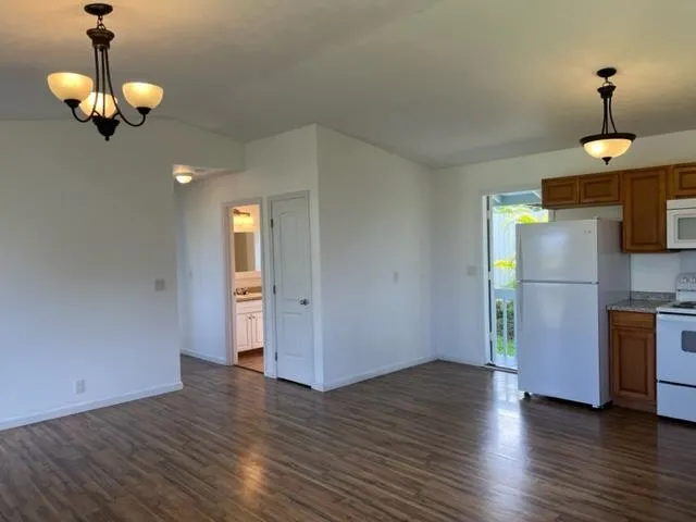a view of a room with wooden floor and chandelier
