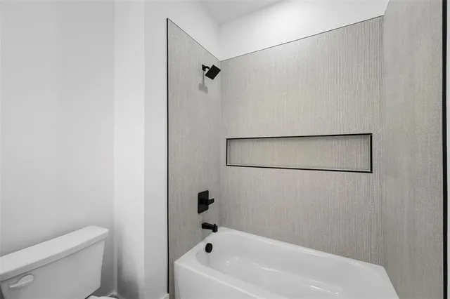 a bathroom with a bathtub and a toilet