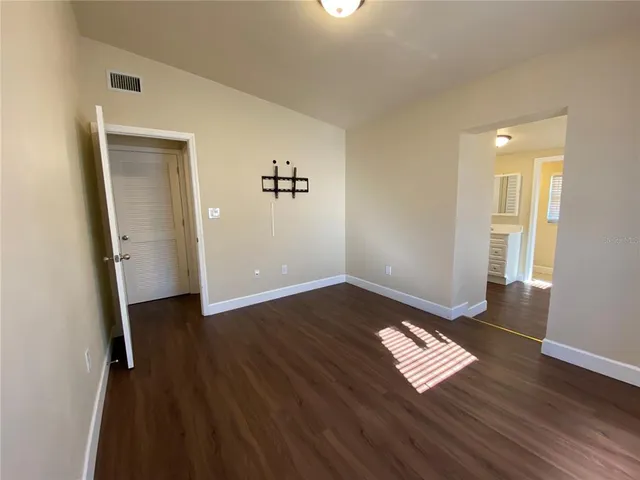 a view of a room with wooden floor and windows