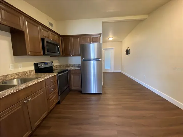 a kitchen with stainless steel appliances a refrigerator and a sink
