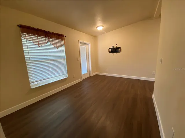 a view of an empty room with glass door