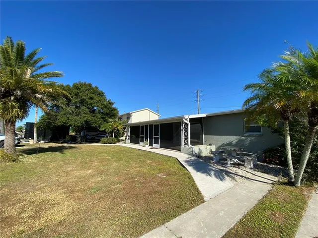 a view of a house with swimming pool and sitting area