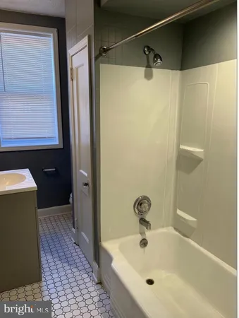 a bathroom with a bathtub and shower