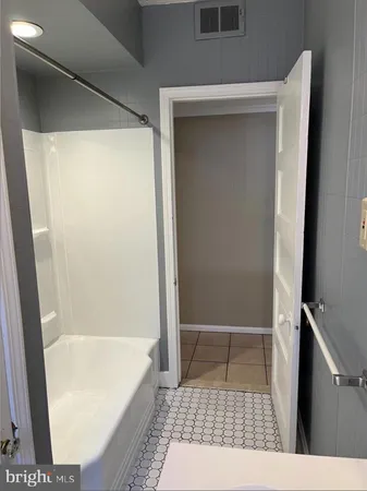 a bath room with a shower and a sink