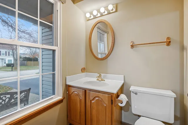 a bathroom with a sink a toilet and a mirror