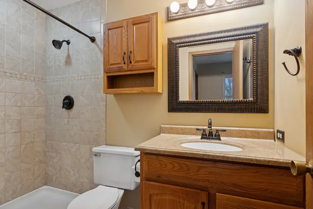 a bathroom with a sink toilet and mirror
