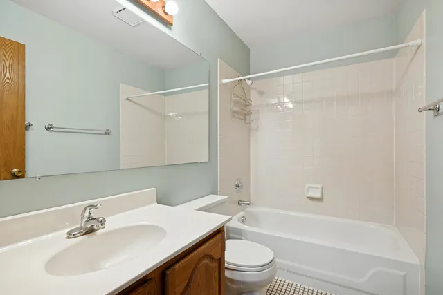 a bathroom with a sink mirror toilet and bathtub