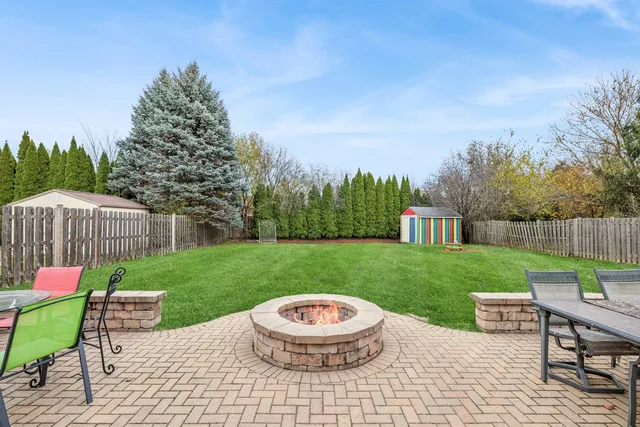 a view of a backyard with sitting area furniture and garden
