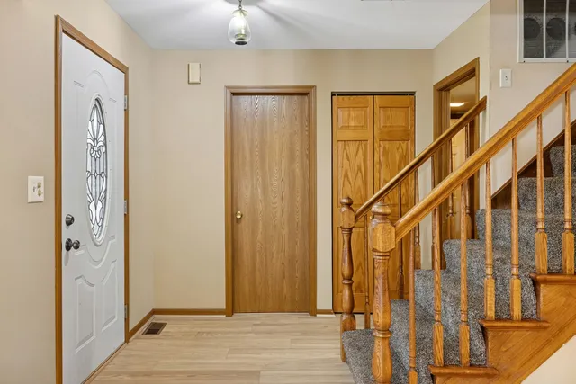 a view of an entryway with wooden floor and door