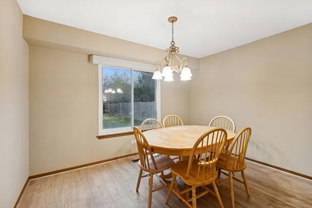 a view of a dining room with furniture wooden floor and chandelier