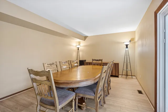 a dining room with furniture and wooden floor