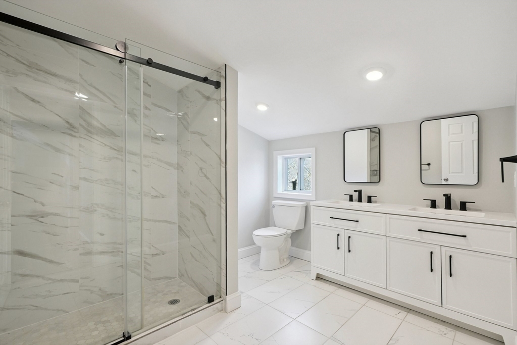 49 Jamaica Street, Unit 2 Boston, MA 02130 - Photo 14 of 19 a bathroom with a double vanity sink mirror and shower