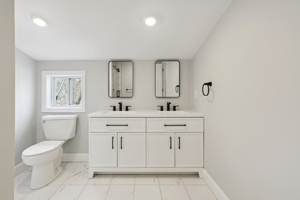 49 Jamaica Street, Unit 2 Boston, MA 02130 - Photo 16 of 19 a spacious bathroom with a sink toilet and mirror