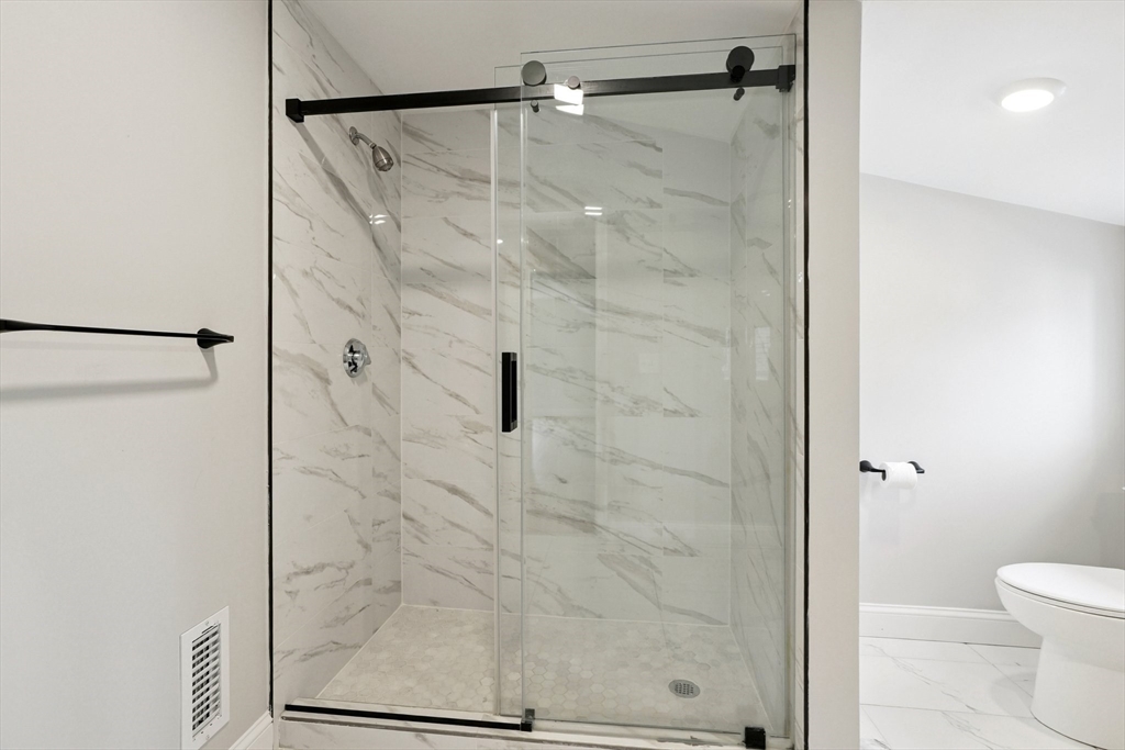 49 Jamaica Street, Unit 2 Boston, MA 02130 - Photo 17 of 19 a bathroom with a shower and toilet