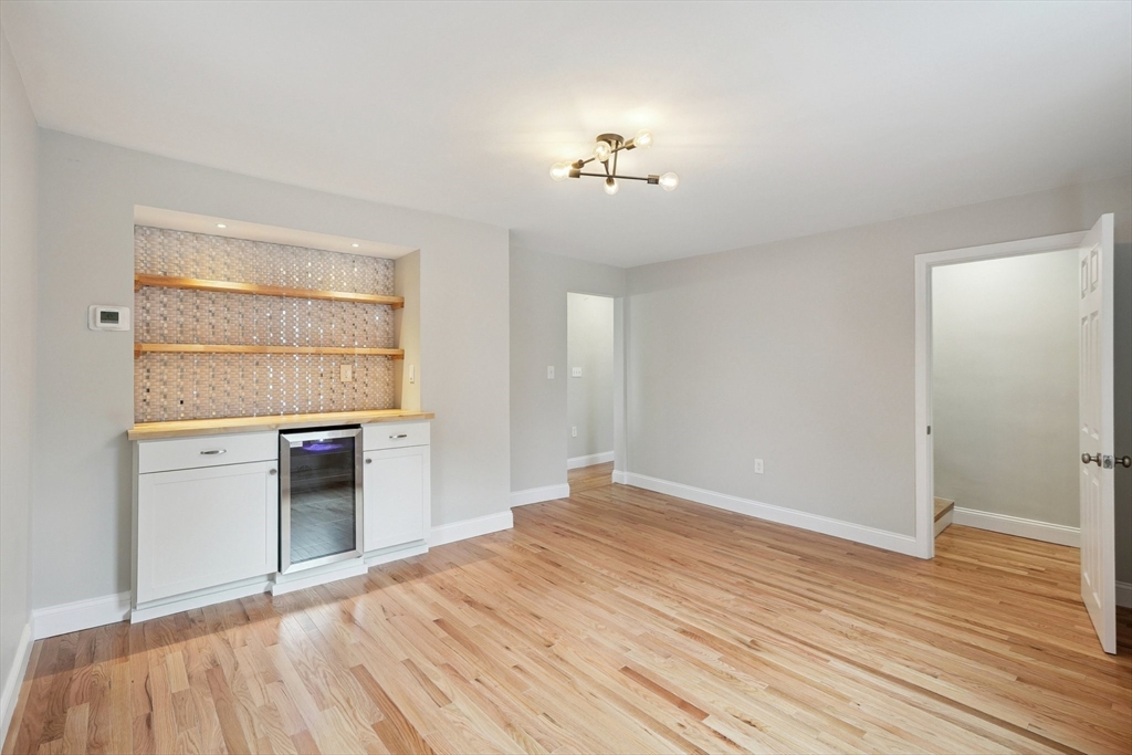 49 Jamaica Street, Unit 2 Boston, MA 02130 - Photo 9 of 19 an empty room with wooden floor cabinet and windows