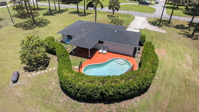 an aerial view of a house with a swimming pool