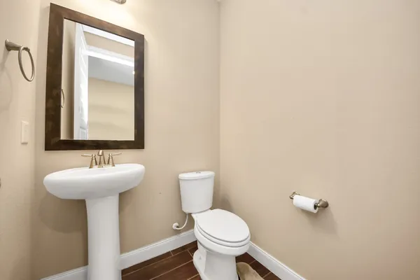 a bathroom with a sink toilet and mirror