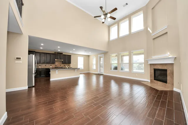 a view of empty room with wooden floor and fireplace