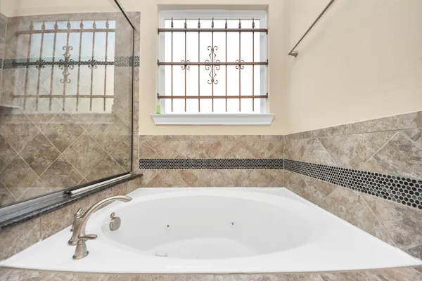 a bathroom with a bathtub and a window