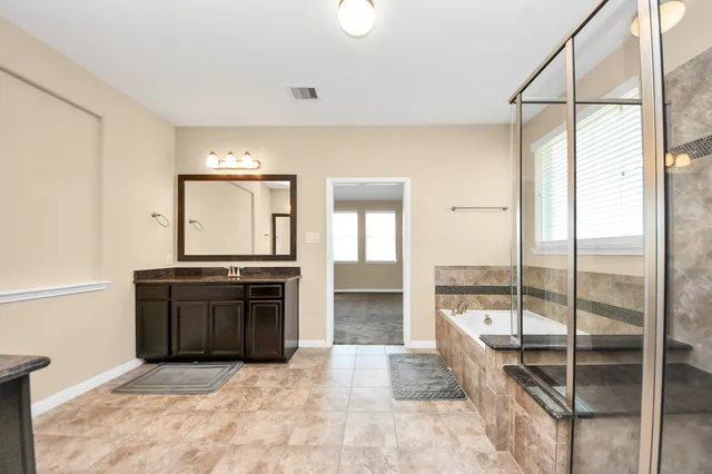 a kitchen with stainless steel appliances granite countertop a stove and a refrigerator