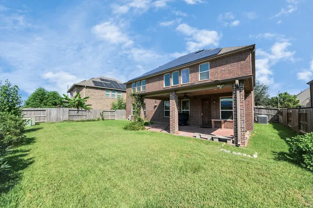 a view of a house with a yard and sitting area