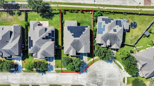 an aerial view of a house with garden space and outdoor seating