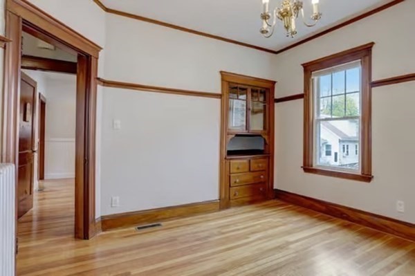 42 Lagrange Street, Unit 1 Boston, MA 02132 - Photo 13 of 29 a view of empty room with wooden floor and fan