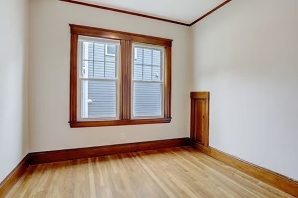 42 Lagrange Street, Unit 1 Boston, MA 02132 - Photo 15 of 29 a view of an empty room with wooden floor and a window