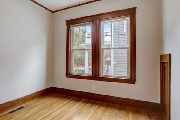 42 Lagrange Street, Unit 1 Boston, MA 02132 - Photo 16 of 29 a view of an empty room with wooden floor and a window