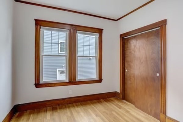 42 Lagrange Street, Unit 1 Boston, MA 02132 - Photo 19 of 29 a view of an empty room with a window and wooden floor