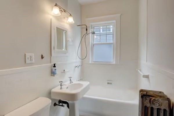42 Lagrange Street, Unit 1 Boston, MA 02132 - Photo 22 of 29 a bathroom with a sink a bathtub and a mirror