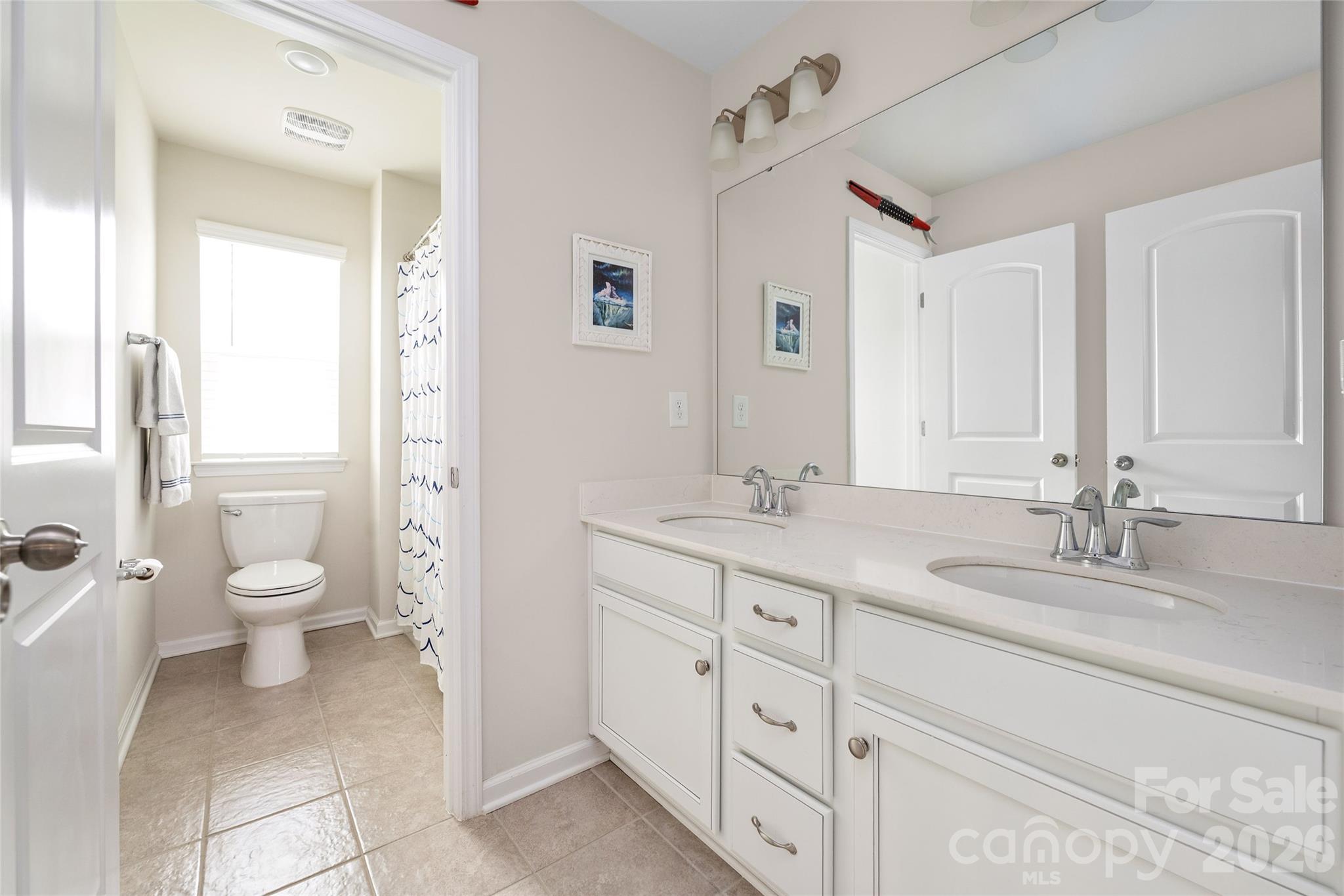 17219 Shearer Road Davidson, NC 28036 - Photo 24 of 34 a bathroom with a granite countertop sink mirror and toilet