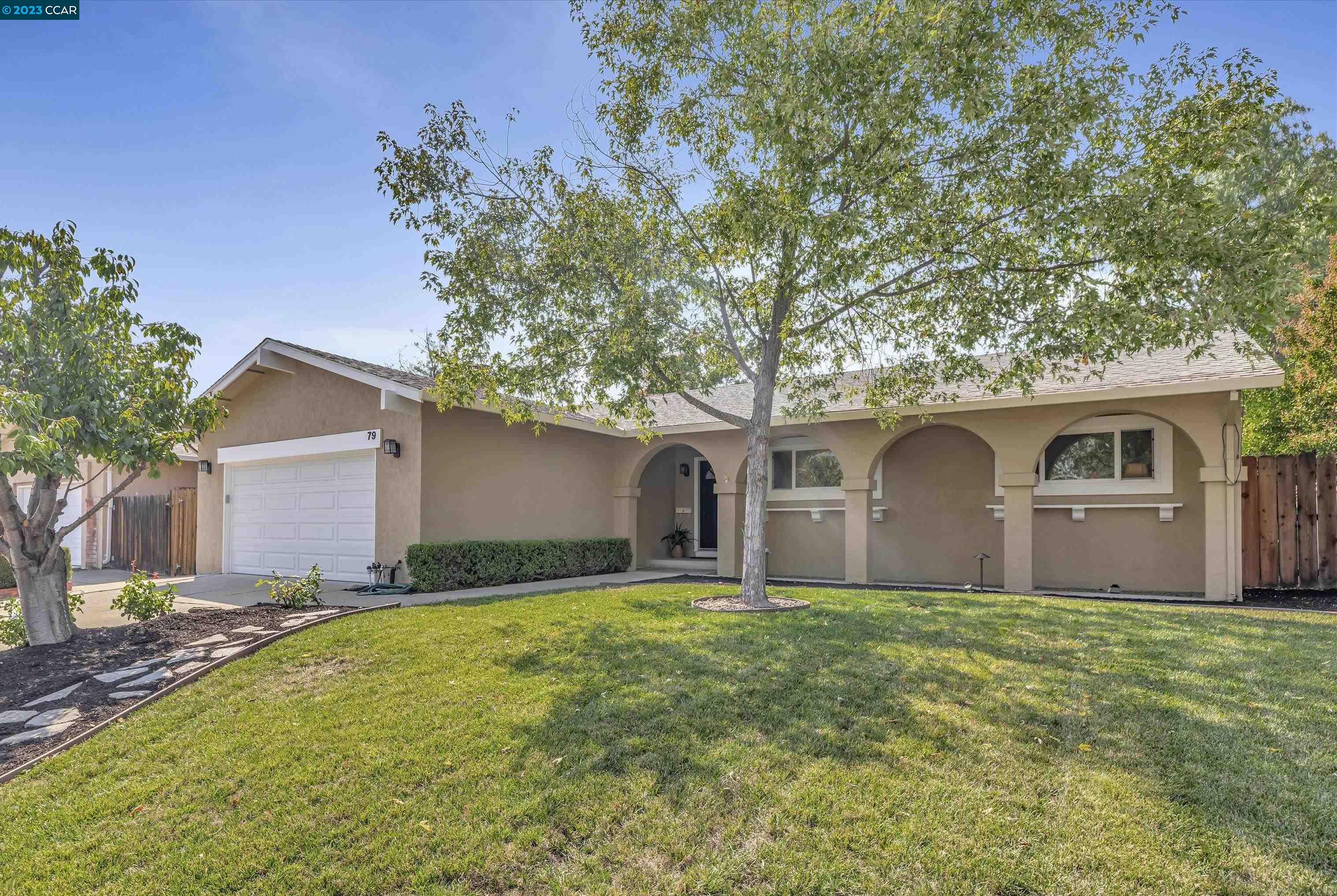 a front view of house with yard and trees