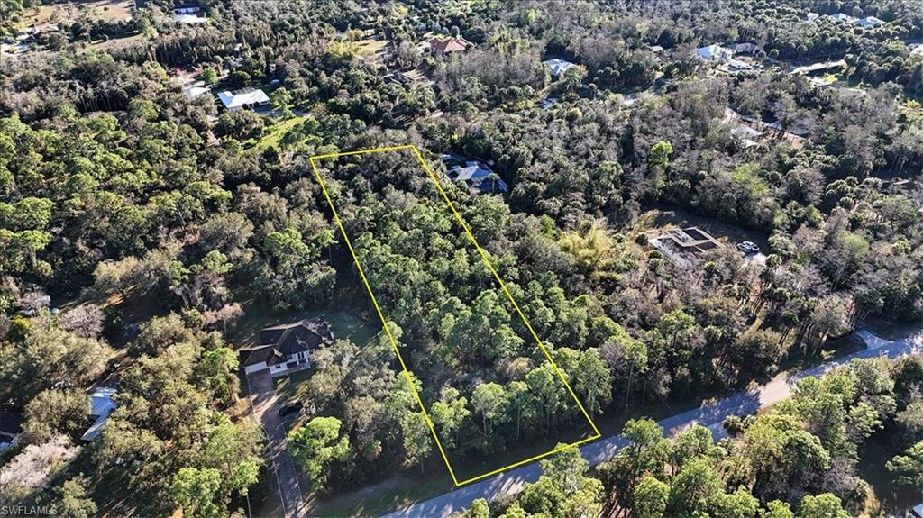 4-xx 18th Avenue Northwest Naples, FL 34102 - Photo 3 of 6 an aerial view of residential house with outdoor space and trees all around