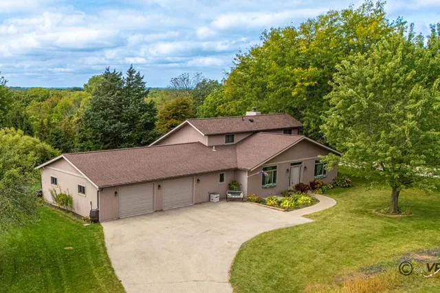a view of a big house with a big yard and large tree