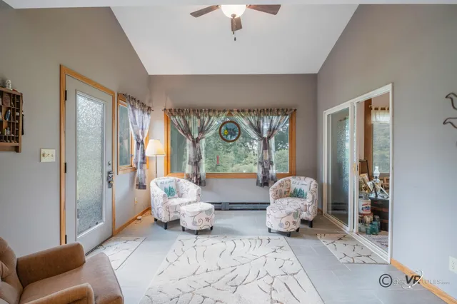 a bedroom with furniture and large windows