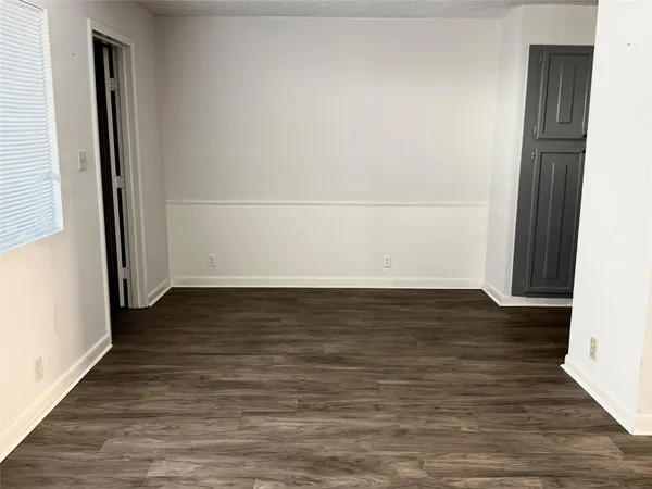 a view of a room with wooden floor
