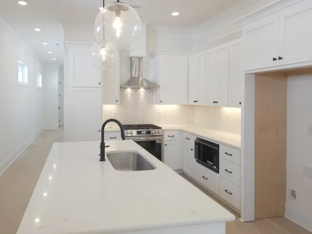 a stove top oven sitting inside of a kitchen